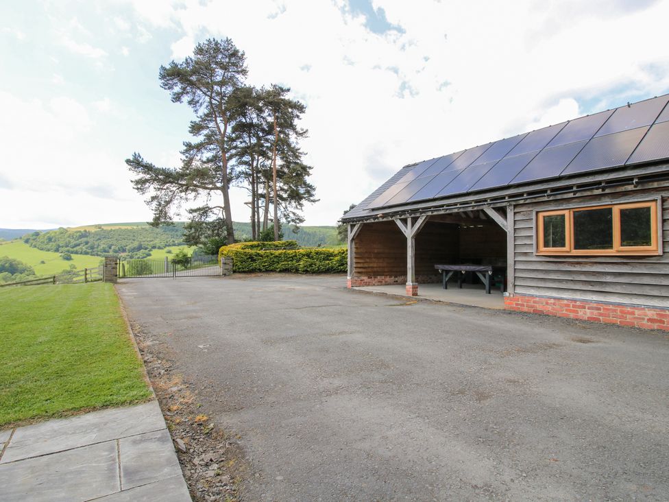 An outdoor area with a building and a view of hills at The Hayloft in Bleddfa near Knighton