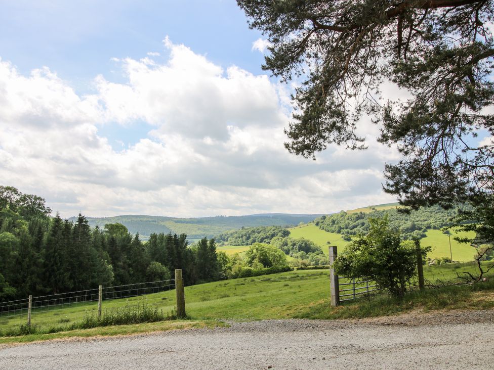 A landscape view with trees and hills at The Hayloft in Bleddfa near Knighton