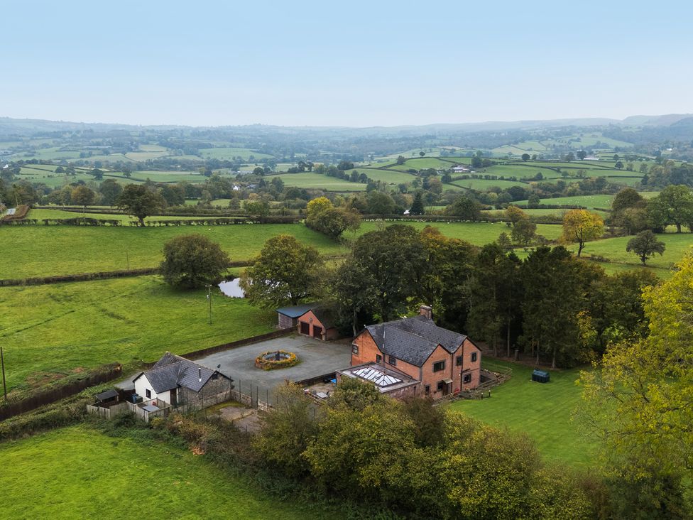 An aerial view of a house with garden and garage at Ty Newydd in Llangadfan