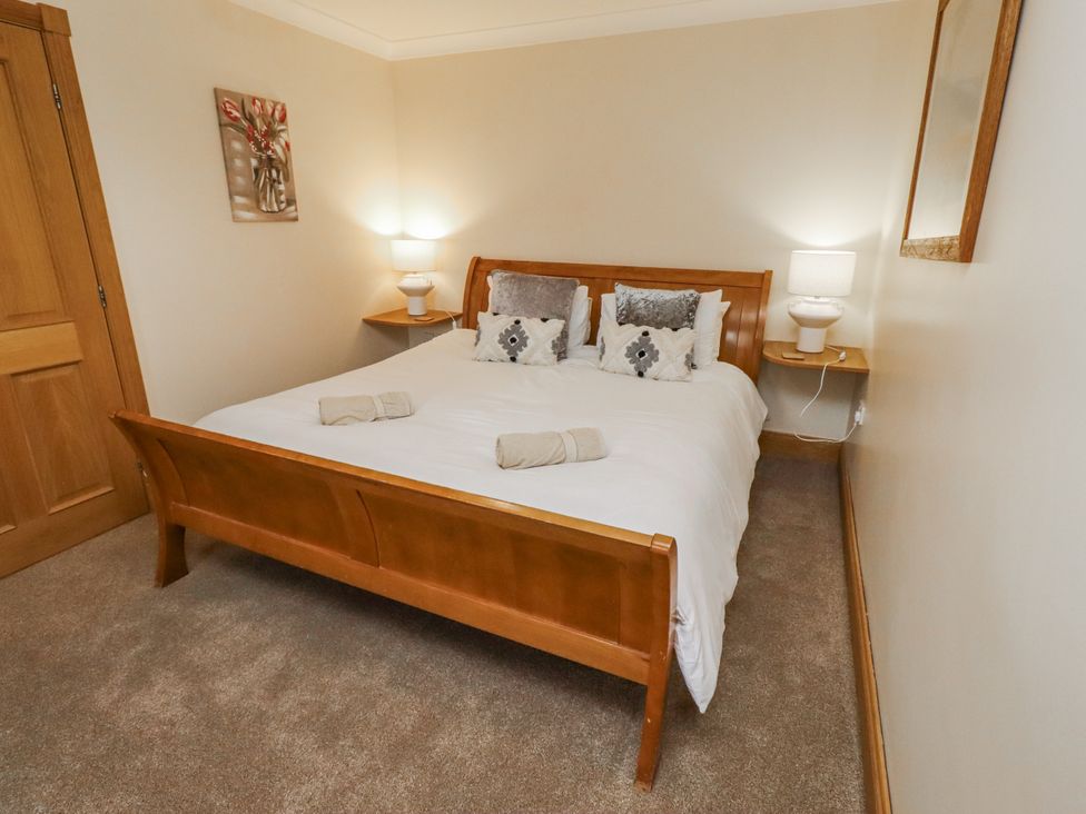 A bedroom with a double bed and bedside tables at High Hemmel House Embleton