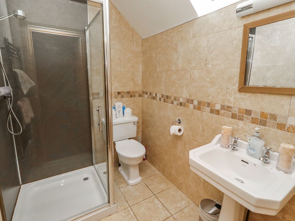 A bathroom with a shower and sink at High Hemmel House in Embleton