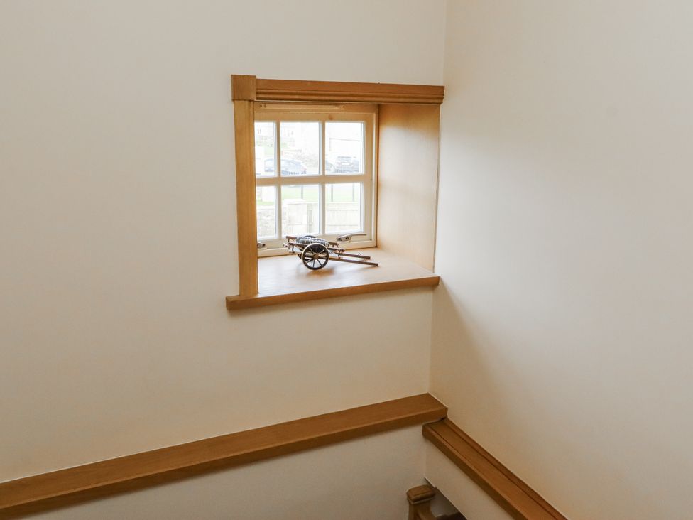 A window with a model cart on the shelf in a staircase at High Hemmel House Embleton