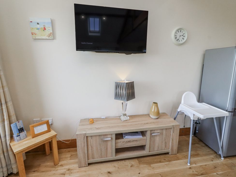 A living room with a television and a coffee table at Home Stead Cottage in Embleton