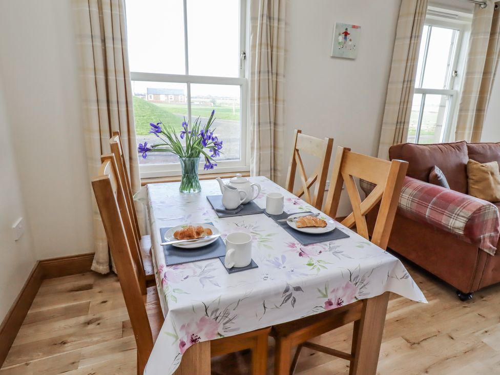 A dining room with a table set for breakfast at Home Stead Cottage in Embleton