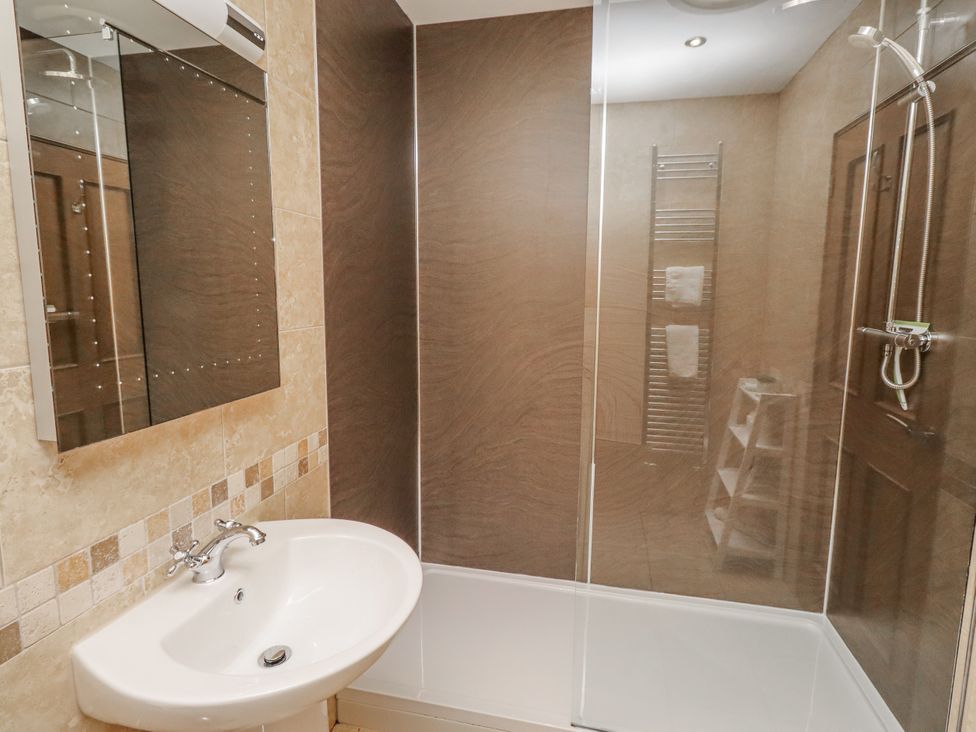 A bathroom with a sink and shower at Home Stead Cottage in Embleton