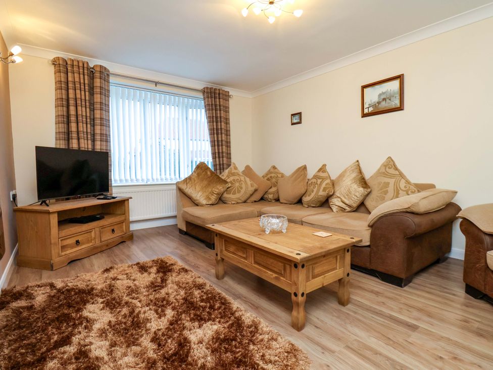 A living room with a sofa and coffee table at La Rochelle in Whitby