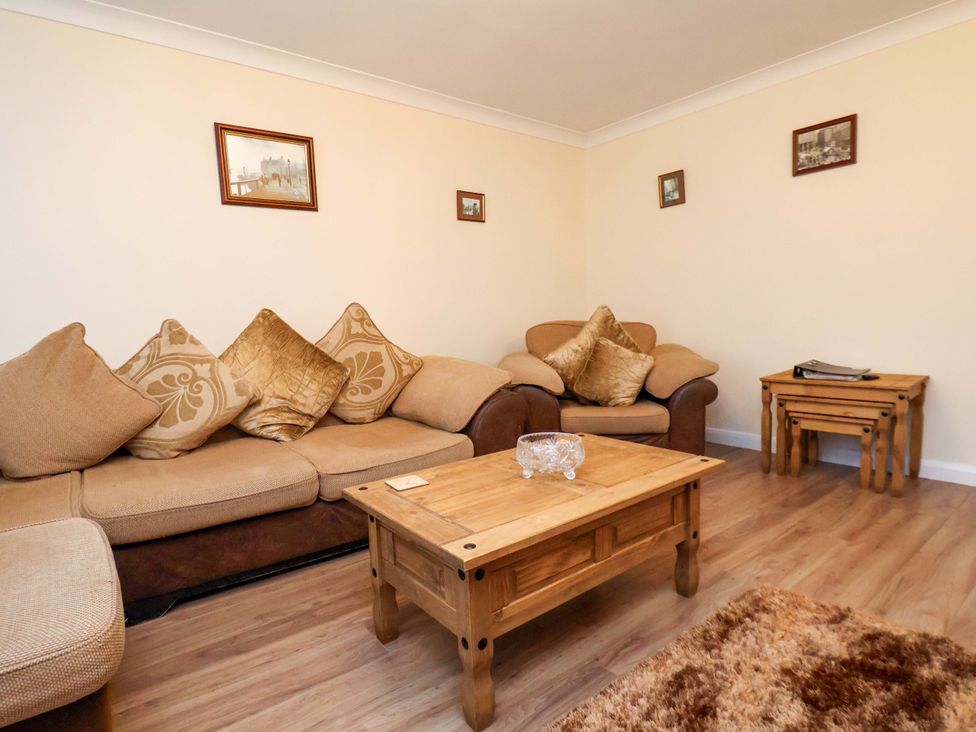 A living room with a sofa and coffee table at La Rochelle in Whitby