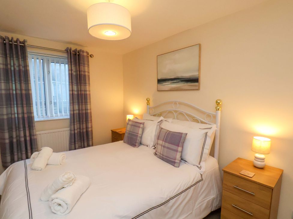 A bedroom with a bed and bedside tables at La Rochelle in Whitby