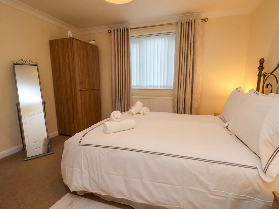 A bedroom with a double bed and wardrobe at La Rochelle in Whitby