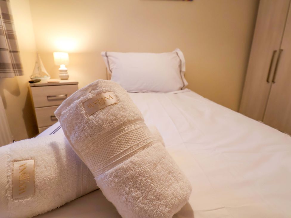 A bedroom with towels on a bed at La Rochelle in Whitby