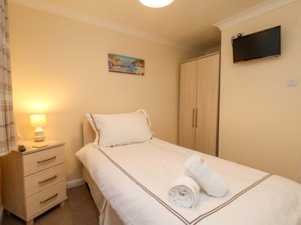 A bedroom with a bed and nightstand at La Rochelle in Whitby