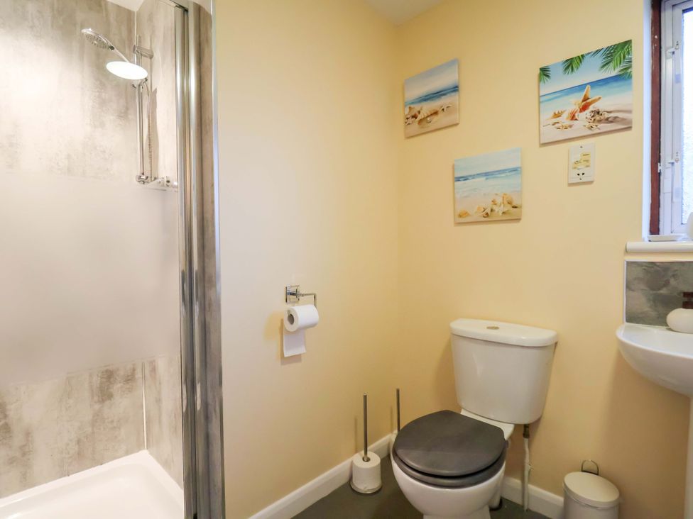 A bathroom with a shower, toilet, and sink at La Rochelle in Whitby
