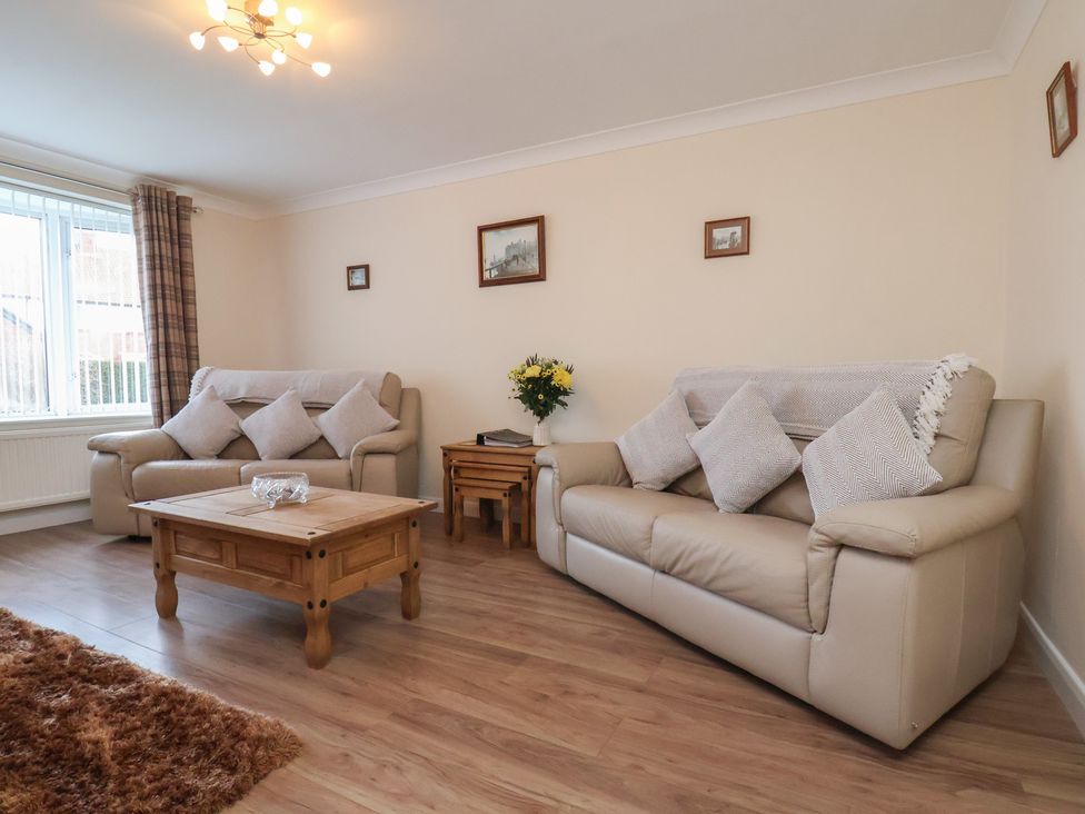 A living room with two sofas and a coffee table at La Rochelle in Whitby