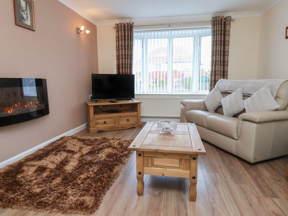 A living room with a sofa and coffee table at La Rochelle in Whitby
