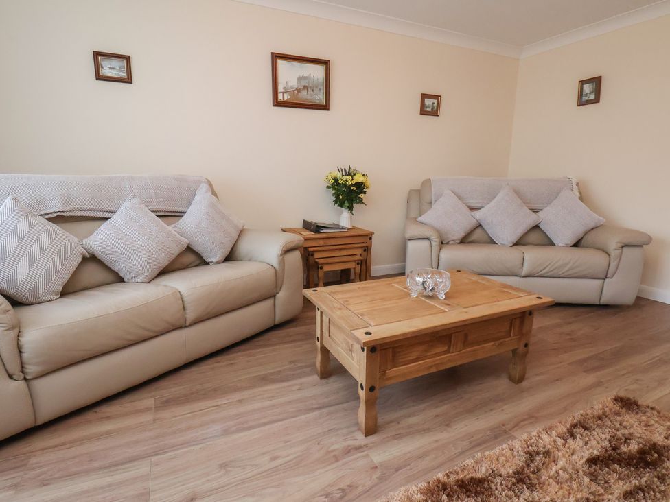 A living room with sofas and a coffee table at La Rochelle in Whitby