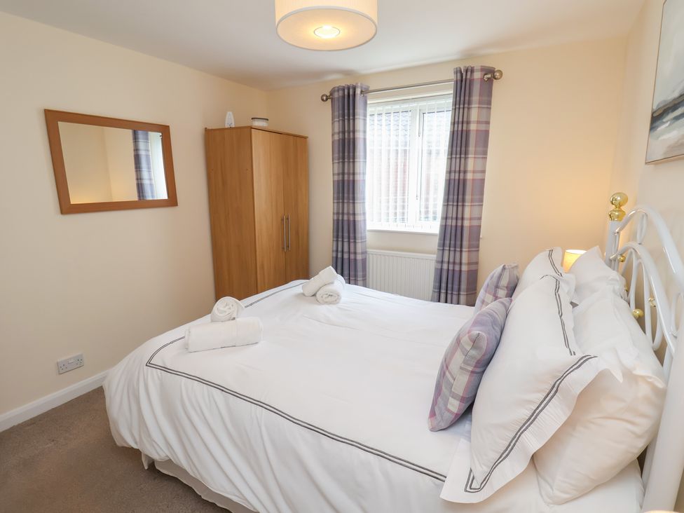 A bedroom with a bed and wardrobe at La Rochelle in Whitby