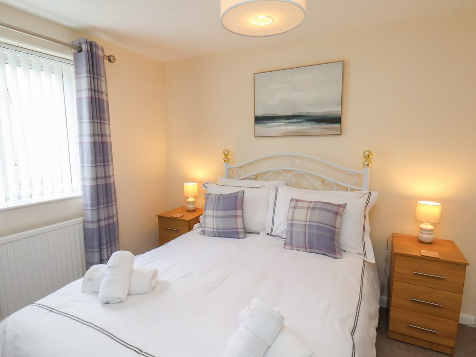 A bedroom with a bed and bedside tables at La Rochelle in Whitby