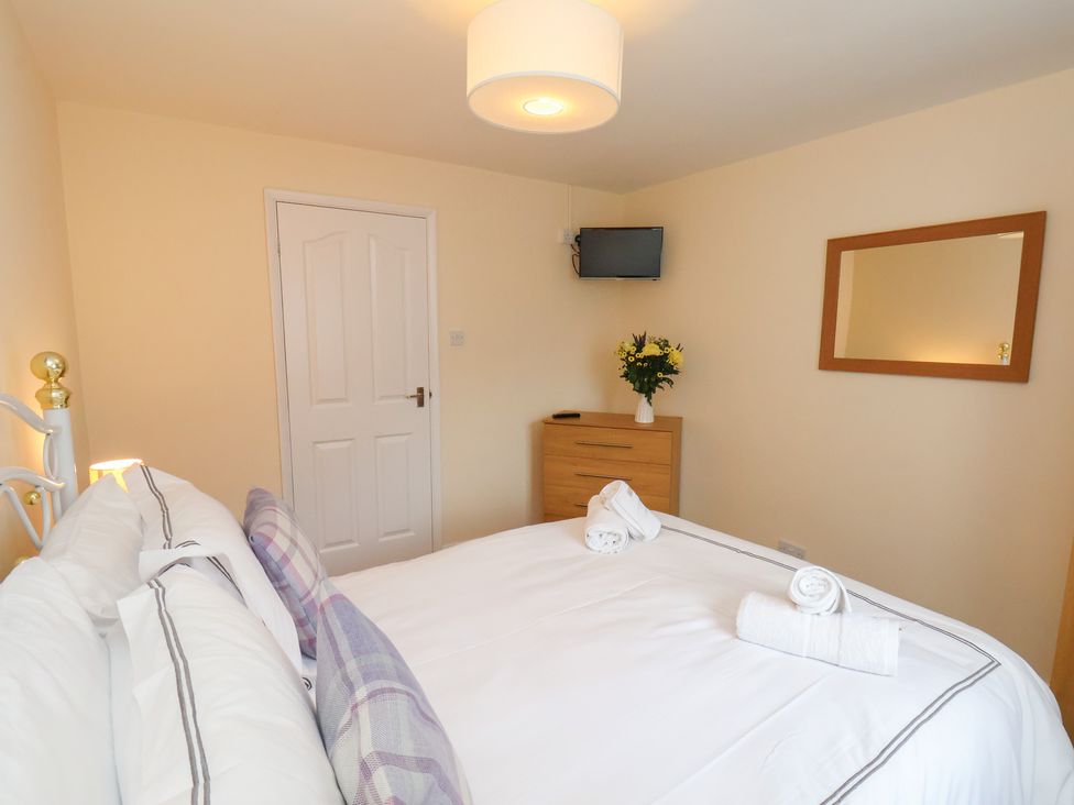 A bedroom with a bed and a television at La Rochelle in Whitby