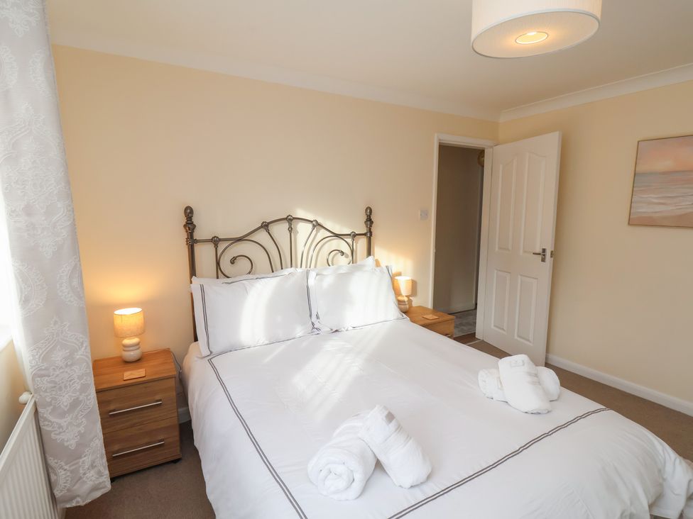 A bedroom with a bed and nightstand at La Rochelle in Whitby