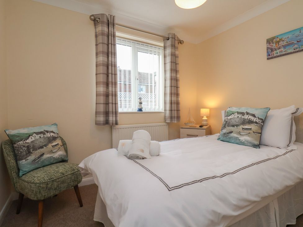 A bedroom with a bed and chair at La Rochelle in Whitby