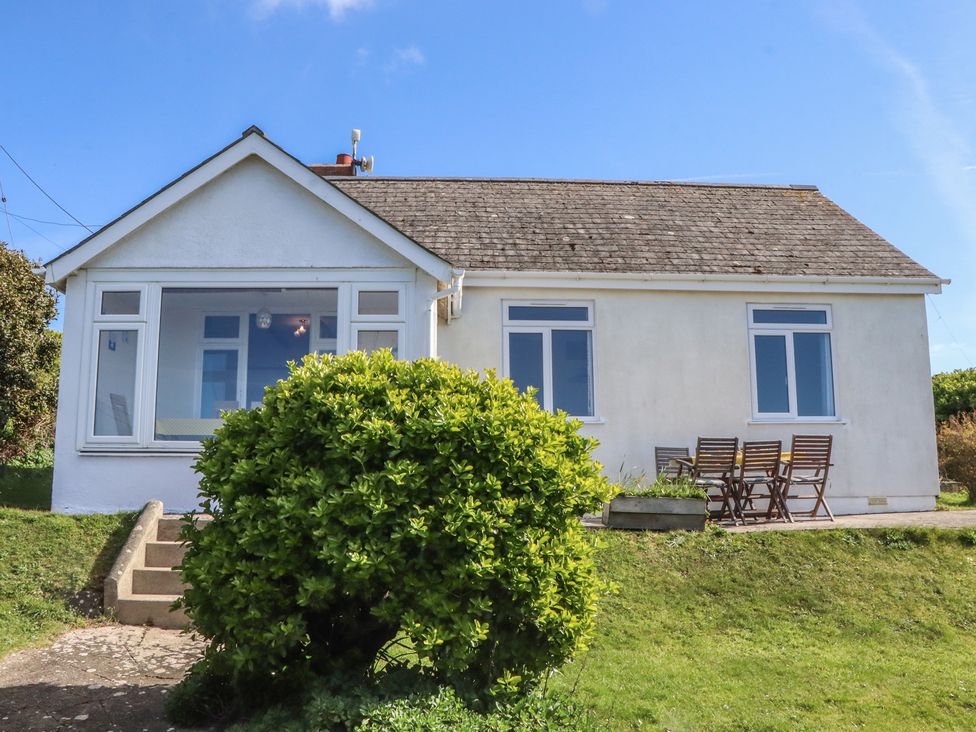 A house with a garden and outdoor seating at Highdown in Bigbury on Sea near Modbury
