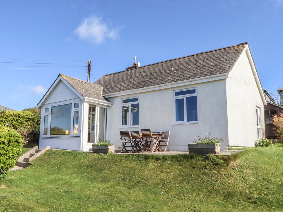 A house with a terrace and furniture at Highdown in Bigbury on Sea near Modbury