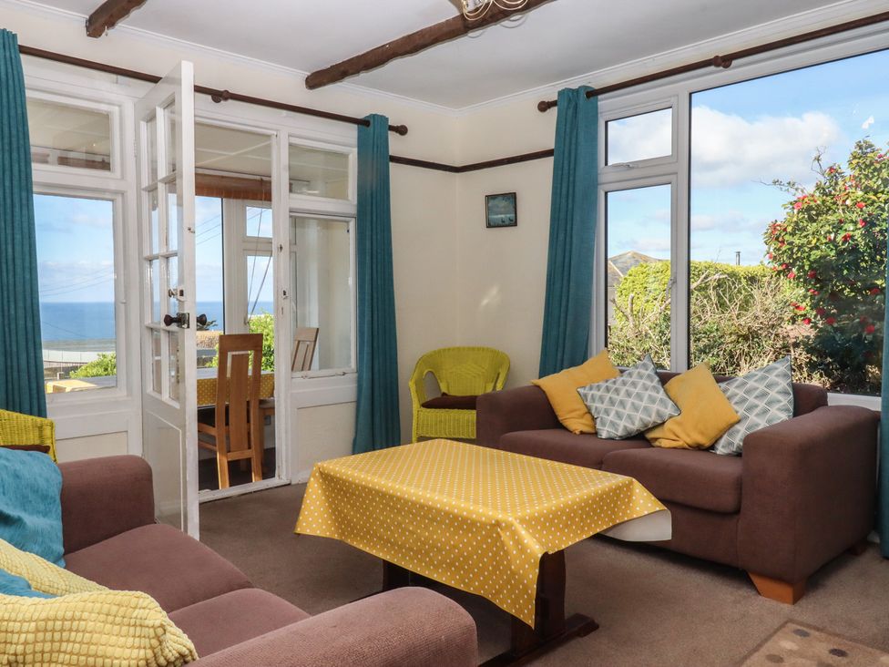 A living room with a sofa and table at Highdown in Bigbury on Sea near Modbury