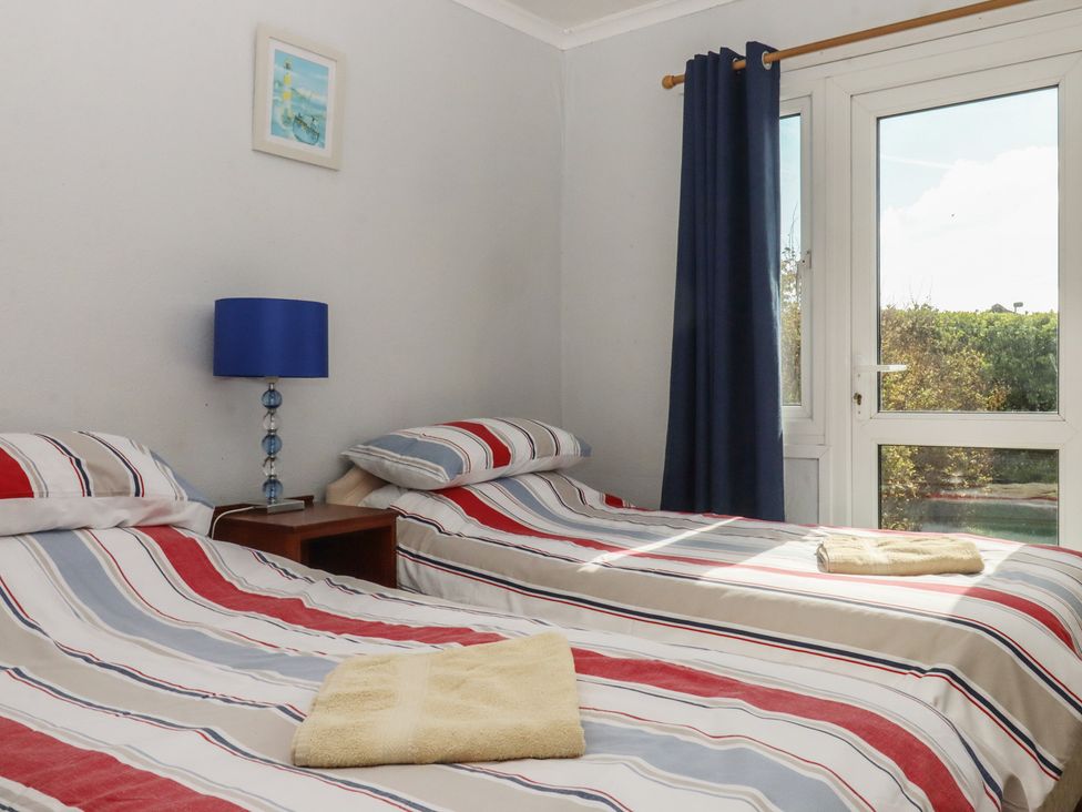 A bedroom with two beds and a window at Highdown Bigbury on Sea near Modbury