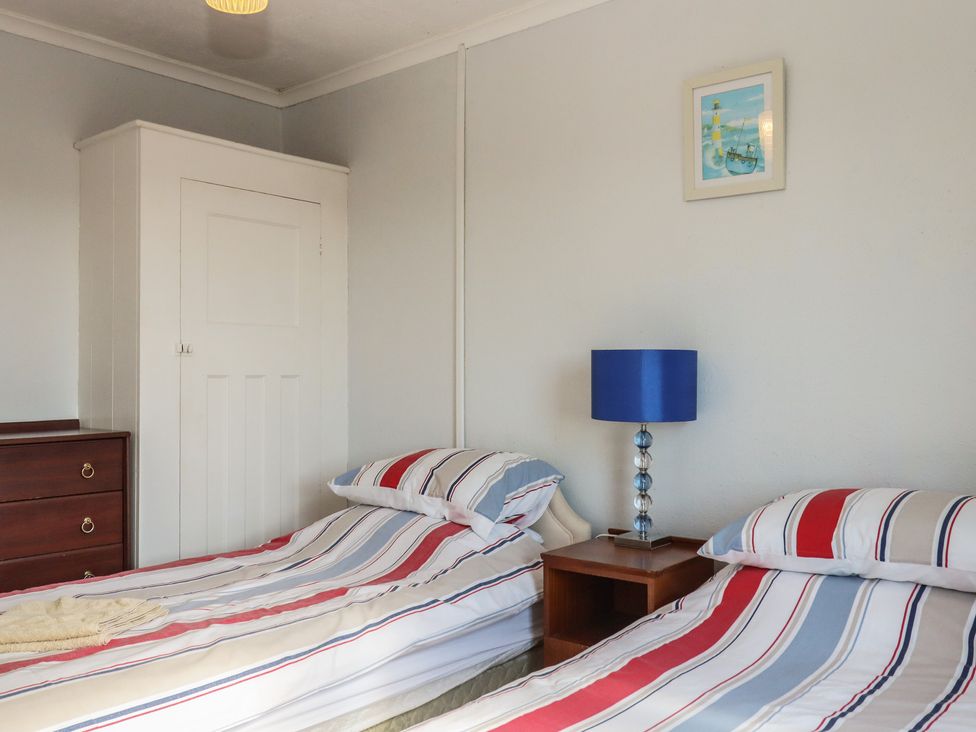 A bedroom with two beds and a dresser at Highdown Bigbury on Sea near Modbury