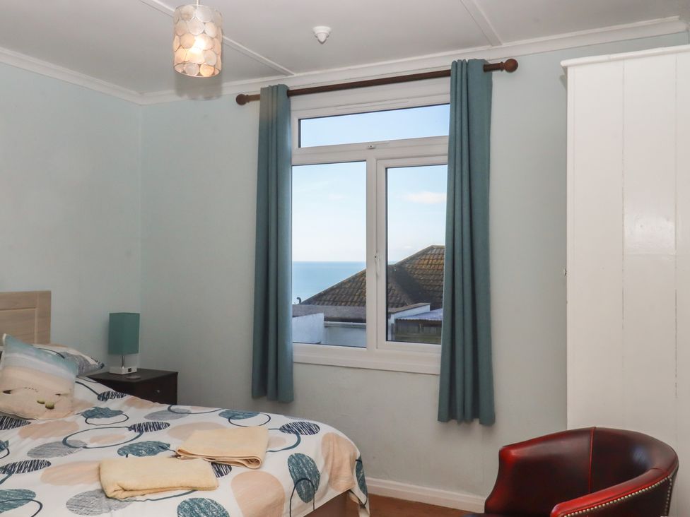 A bedroom with a bed and a window at Highdown Bigbury on Sea near Modbury