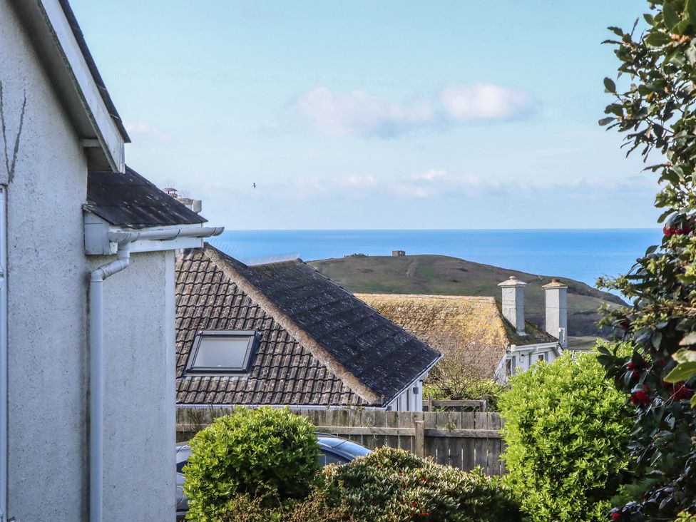 A view of rooftops and the sea at Highdown in Bigbury on Sea near Modbury