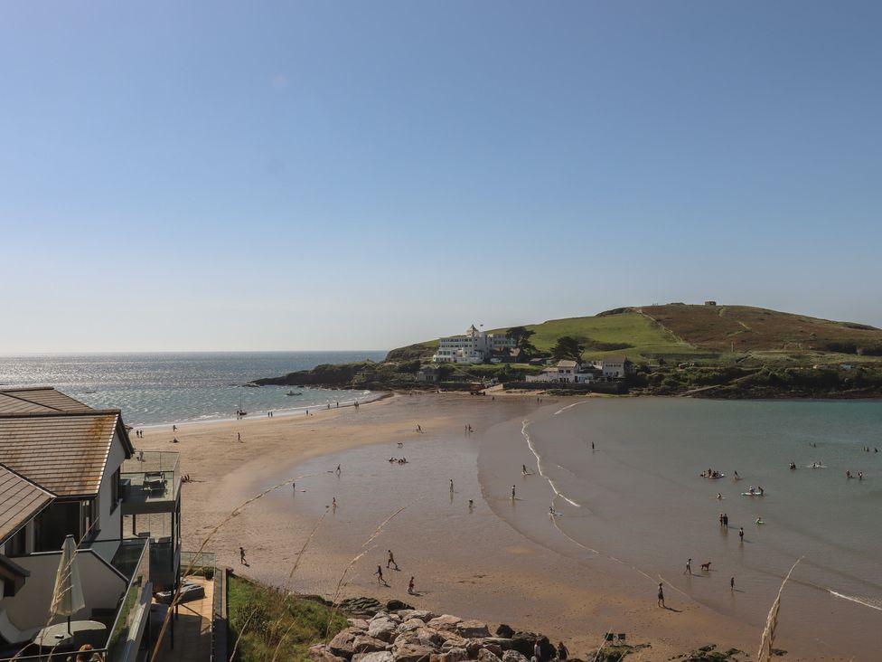 A beach with people enjoying the water at Highdown in Bigbury on Sea near Modbury