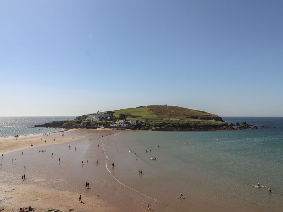 A beach with people walking on sand near the sea at Highdown in Bigbury on Sea near Modbury