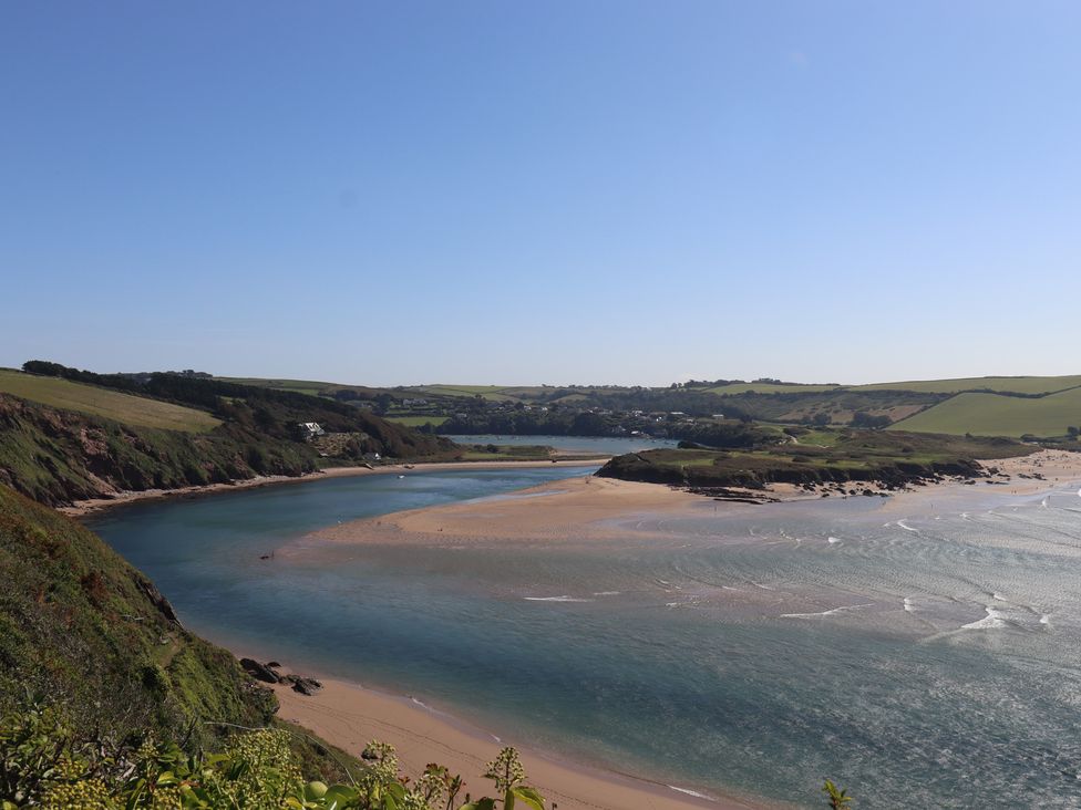 A beach with water and hills at Highdown in Bigbury on Sea near Modbury