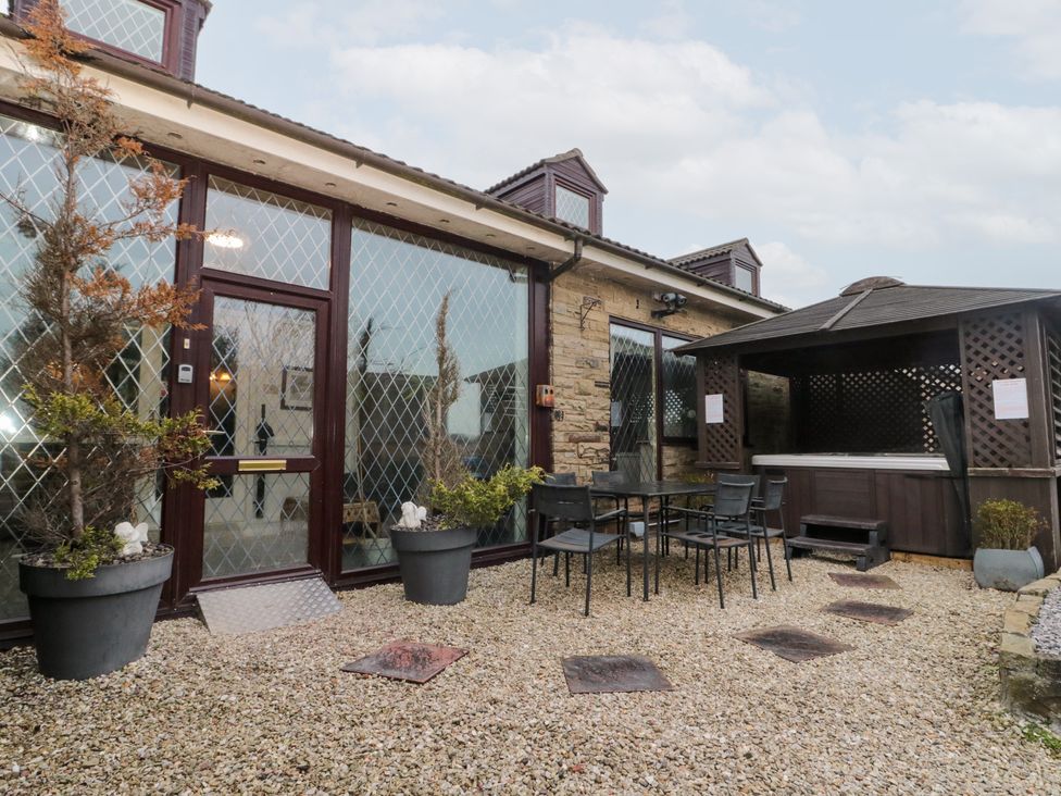 An outdoor area with a table and chairs next to a gazebo at Seacrest Lodge in Scarborough