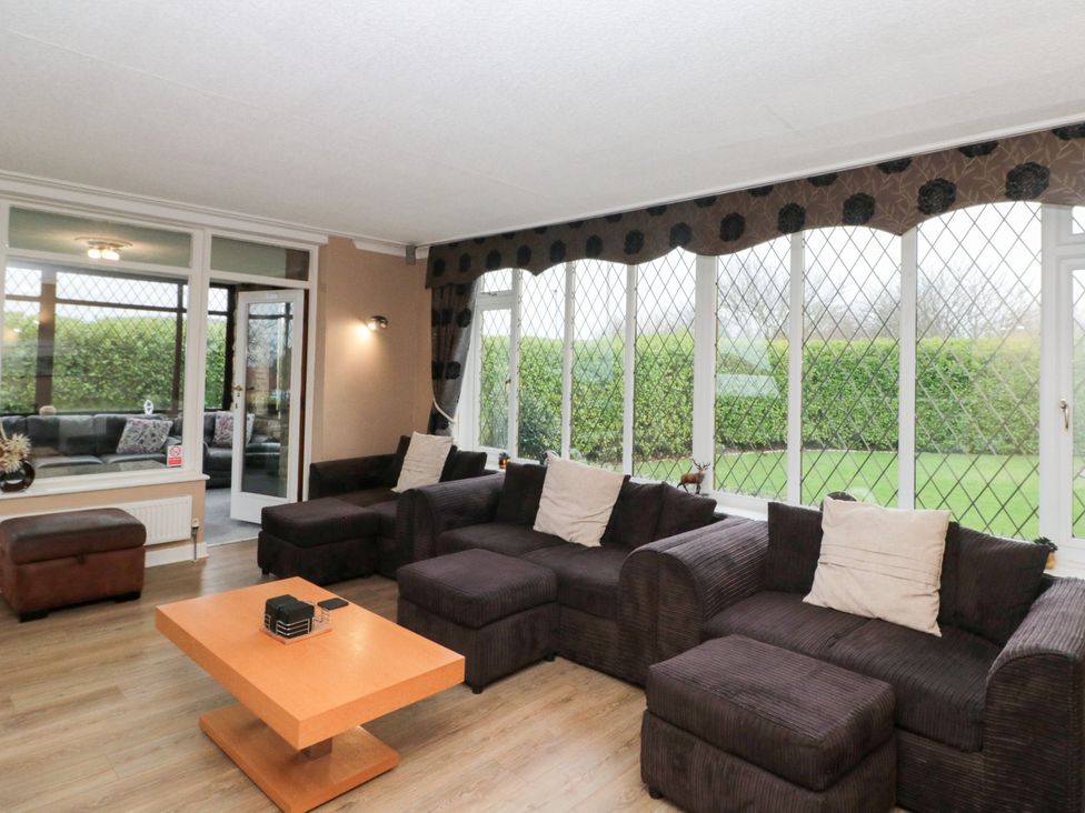 A conservatory with a sofa and coffee table at Seacrest Lodge in Scarborough