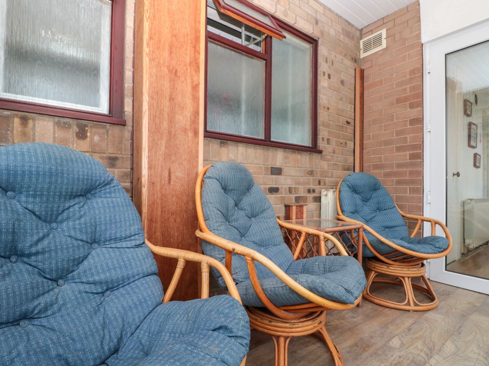 A snug with rocking chairs and windows at Seacrest Lodge Scarborough