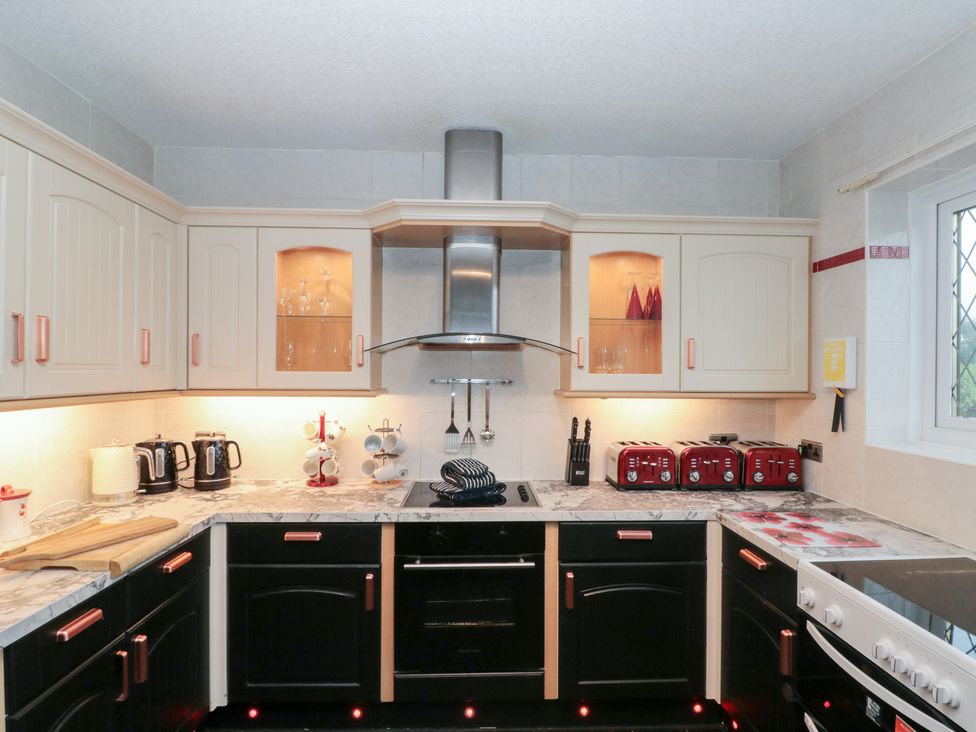 A kitchen with cabinets, stove and kettles at Seacrest Lodge in Scarborough
