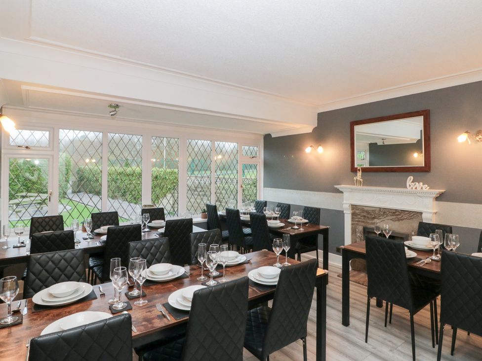 A dining room with tables and chairs at Seacrest Lodge in Scarborough