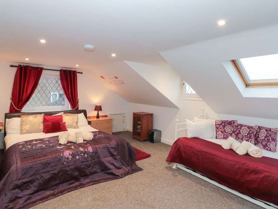 A bedroom with two beds and a dresser at Seacrest Lodge in Scarborough