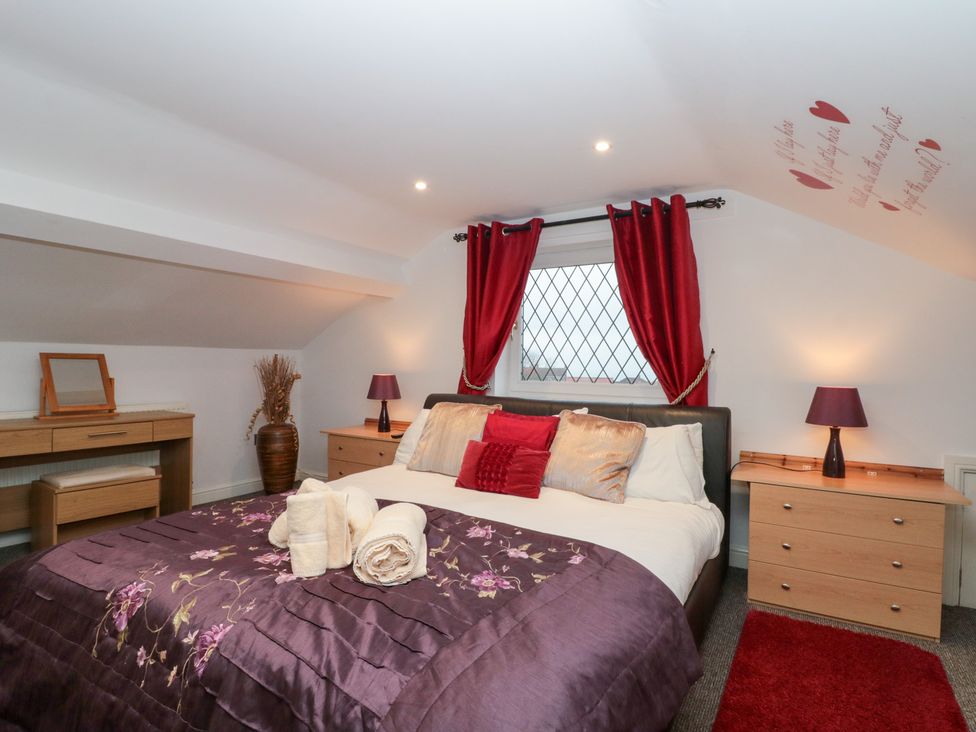 A bedroom with a bed and dresser at Seacrest Lodge in Scarborough