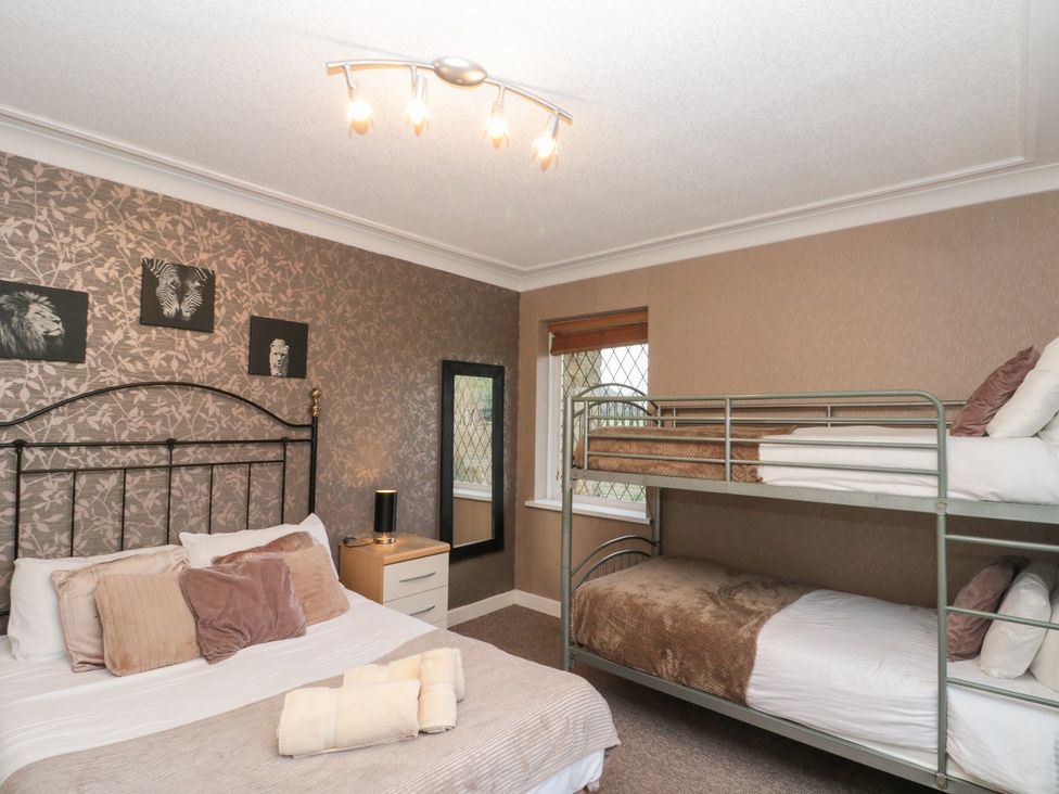 A bedroom with a double bed and a bunk bed at Seacrest Lodge in Scarborough