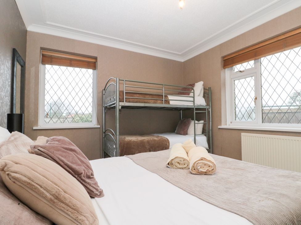 A bedroom with a bunk bed and double bed at Seacrest Lodge in Scarborough