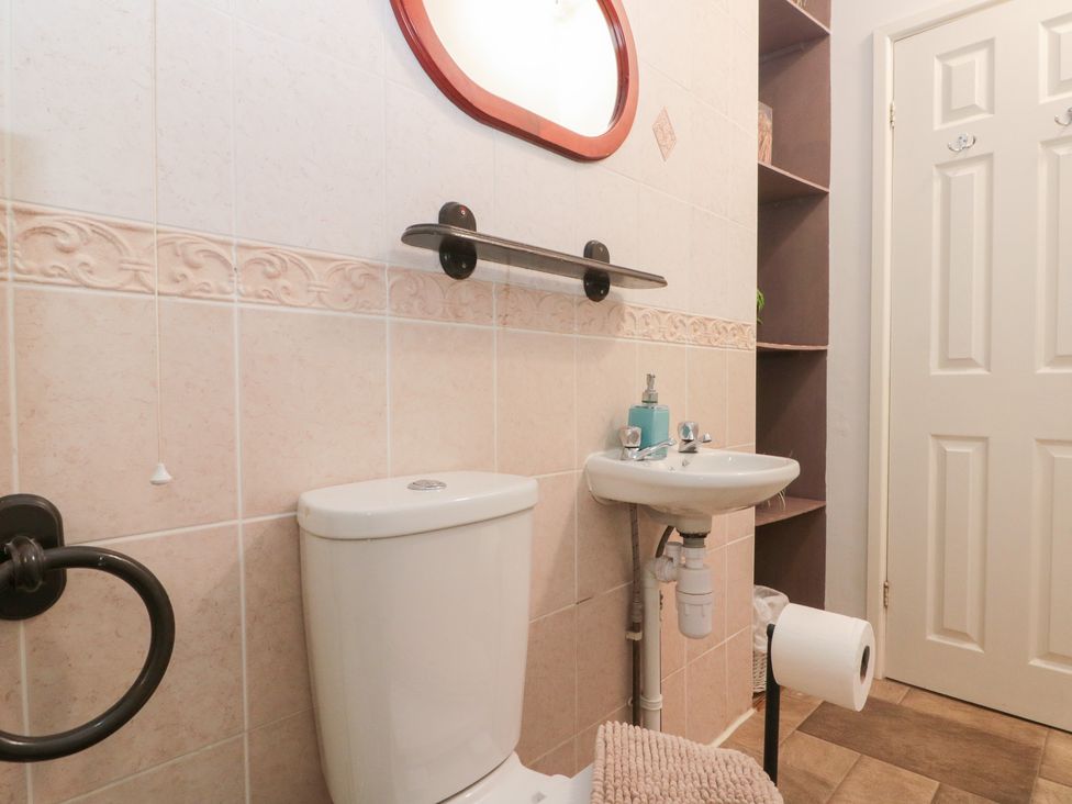 A bathroom with a toilet and sink at Seacrest Lodge in Scarborough