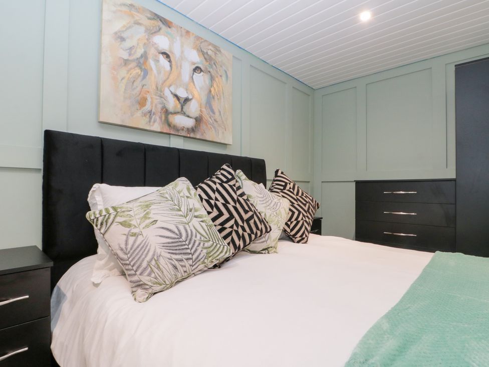 A bedroom with a bed and dresser at Seacrest Lodge in Scarborough