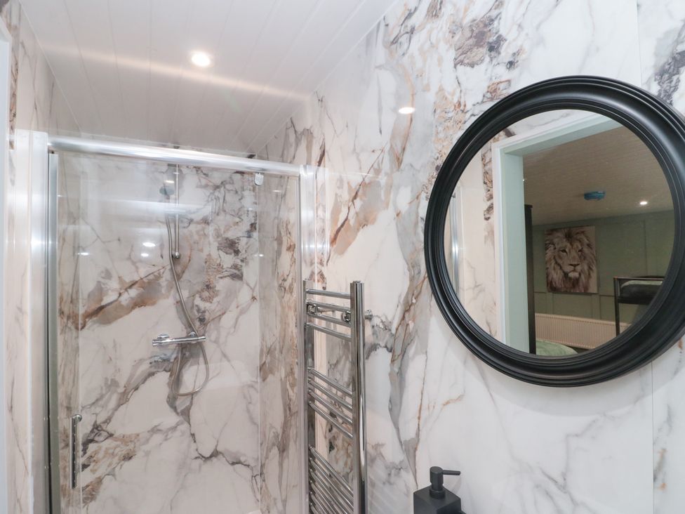 A bathroom with a shower and a towel radiator at Seacrest Lodge in Scarborough