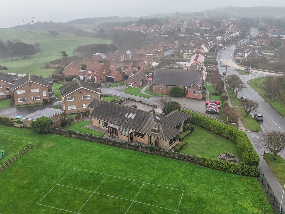 An aerial view of houses and a road in Scarborough