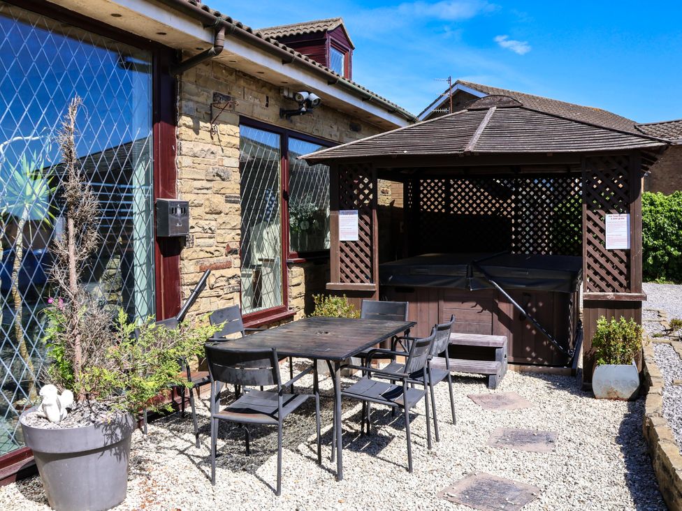 An outdoor area with a table, chairs, and a gazebo at Seacrest Lodge, Scarborough
