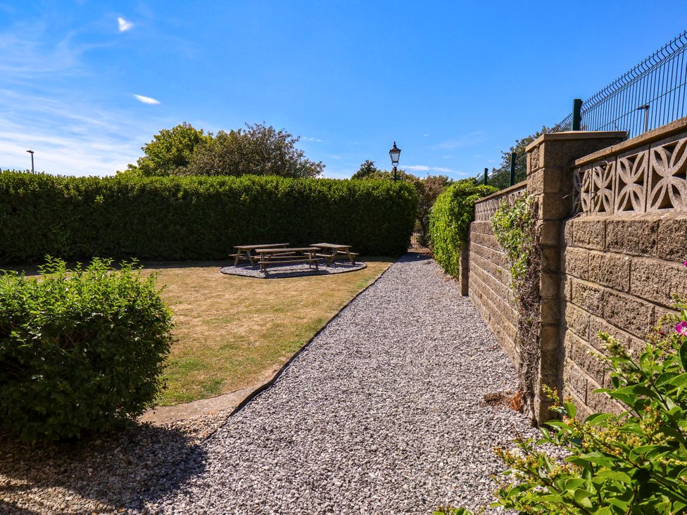 A garden with a gravel path and bench at Seacrest Lodge in Scarborough