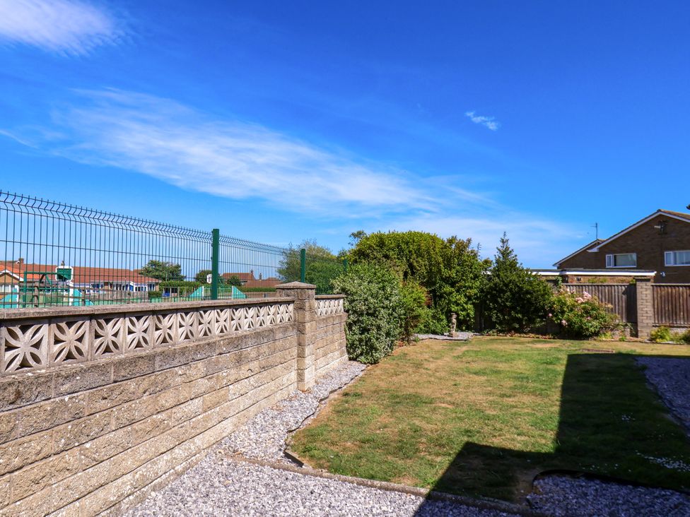 A garden with a wall and fence at Seacrest Lodge in Scarborough
